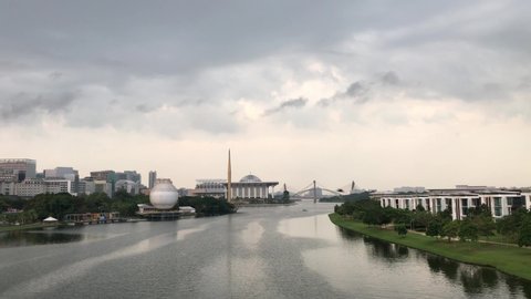 Scenery of Putrajaya iconic view with beautiful architectures and bridges in a clear morning and flying birds.