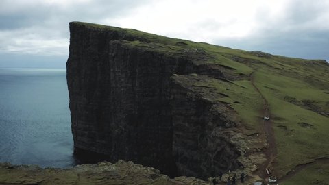 Flight over the Traelanipa cliff located on the island of Vagar in Faroe Islands, Denmark. Traelanipa cliff is a popular tourist destination on Faroe Islands. 4K UHD video.