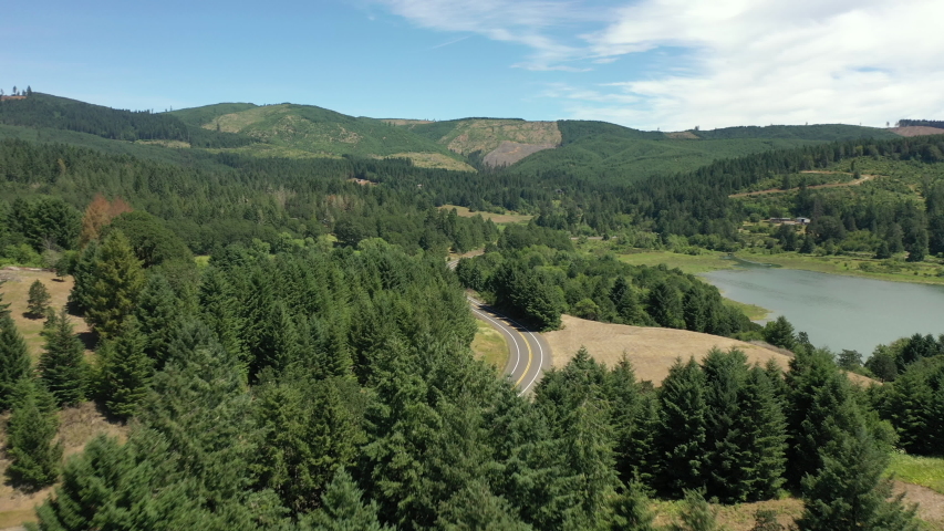 Aerial dolly following the road around Henry Hagg lake in oregon.