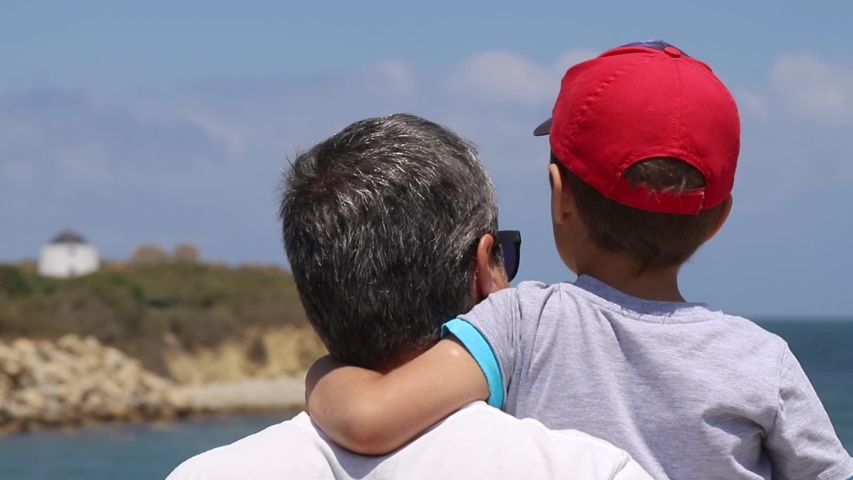 A boy with father watching to the sea | Shutterstock HD Video #1032583634