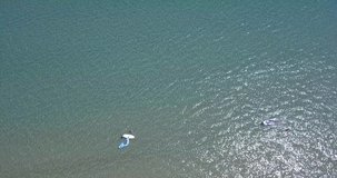 Aerial video of boats in the sea and reveal of island