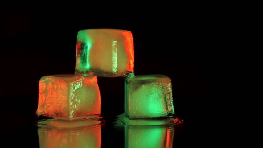 Close up shot of 3 ice cubes on a table at a party