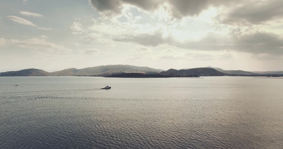 Boat in the sea with intense clouds, Volos, Greece