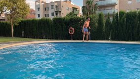 
boy catches the ball jumping into the pool 4k slow motion