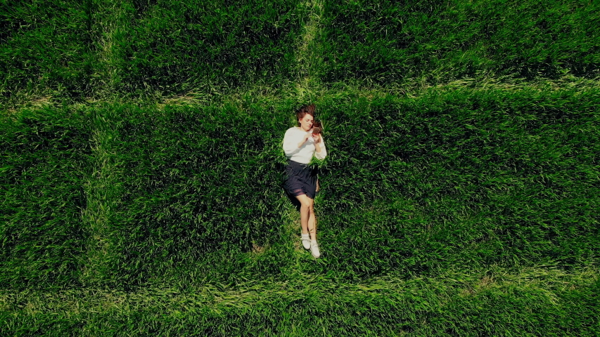 Top view on handsome relaxing female texting on a smartphone