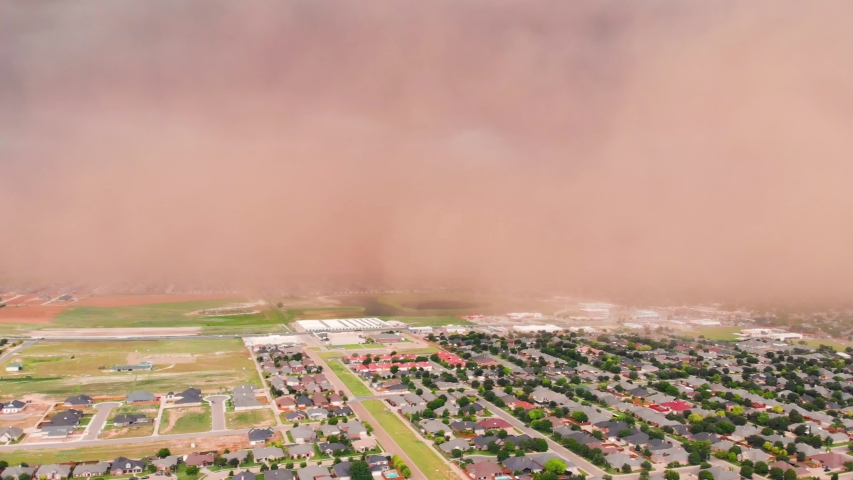4K Ariel pan footage of a giant dust storm or haboob approaching a suburb in Lubbock, Texas