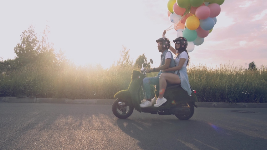 young beautiful hipster couple riding on motorbike, summer europe vacation, traveling, romance, smiling, happy, having fun, sunglasses, stylish outfit, together in love, adventures. Royalty-Free Stock Footage #1032614708