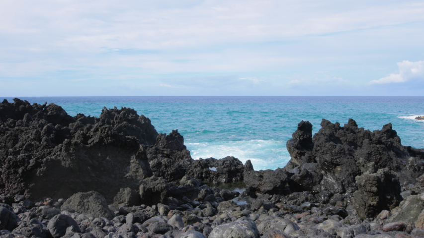 Beautiful blue ocean and large waves crashing into shore on Hawaii.