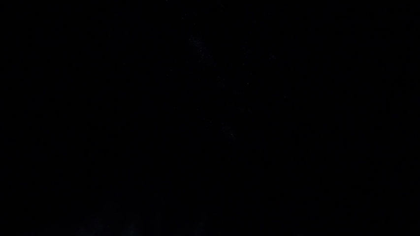 Portrait of beautiful woman with blue sparkles on her face. Girl with art make-up in color Light. Fashion model with colourful makeup