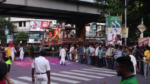 KOLKATA, WEST BENGAL , INDIA - JULY 4th 2019 : Bengali and Odia Hindu devotees dragging Holy rope to pull Rath or chariot, of God Jagannath, Balaram and Goddess Suvadra as an ancient hindu ritual .