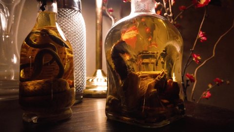 Bottles of alcoholic drink containing preserved snakes