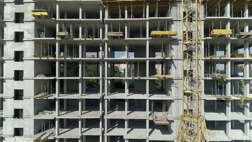 Aerial view of high rise residential complex under construction. Construction of apartment building in green zone. Multi-storey modern residential complex under construction Royalty-Free Stock Footage #1032637106