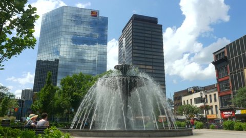 Hamilton, Ontario/Canada - June 30, 2019: Footage of Gore Park fountain located in downtown Hamilton. Shot on a cloudy afternoon. Birds and pedestrians are seen in the footage as well.