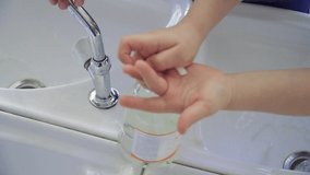Children wash their hands with soap slow motion video