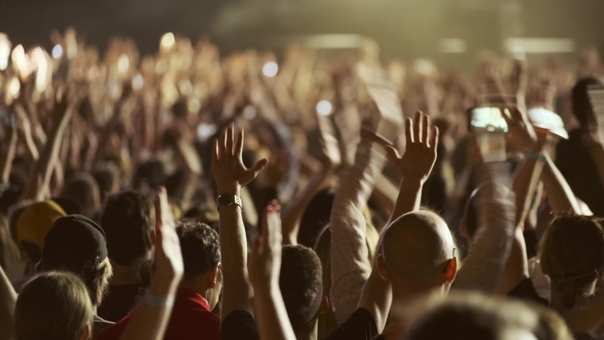 Crowd of fans are cheering at open-air music festival, back view Royalty-Free Stock Footage #1032677390