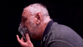 A mature aged balding man with an oxygen mask side view. - Powered by Shutterstock - Get 15% off with code: PIKWIZARD15