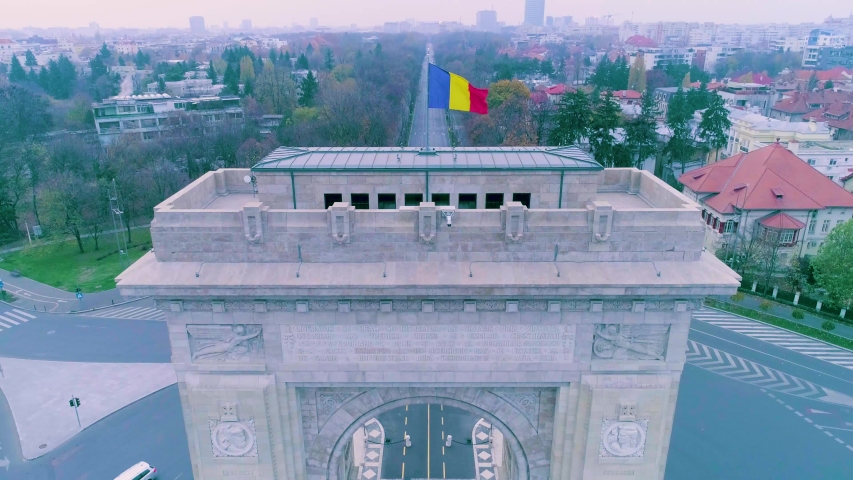 Aerial view of triumphal arch in Bucharest. Morning light. Aerial footage of an arch and boulevards surrounding it on a sunset in Bucharest. Arc de triumph.  Romania Bucharest. Sunrise. Sunset