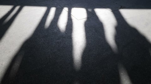 Shadows of people walking stairs.
Video footage of shadows.