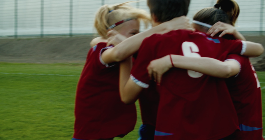 TRACKING Caucasian teenager girl soccer football team celebrating after scoring a goal against opposing team. 4K UHD 60 FPS SLOW MOTION Royalty-Free Stock Footage #1032691109