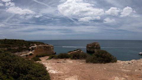 Walking along a trail in the Algarve Coast, near Praia da Marinha beach - Algarve, south of Portugal