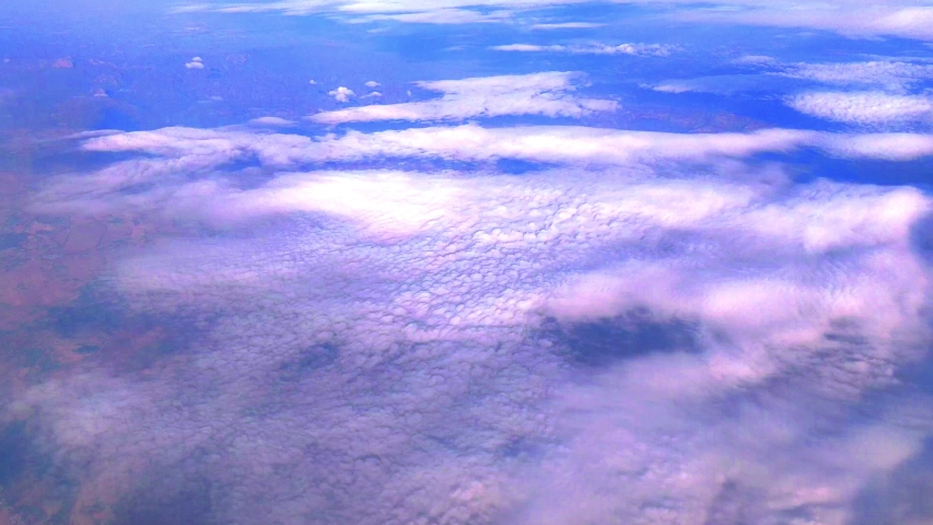 Aerial view of clouds and land beneath it