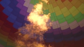 slomo clip of the fire inside a hot air balloon as the camera is moving slowly. the fire burning creating warm air to lift the balloon