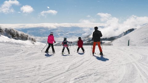 Picturesque View Of Happy Family Riding Ski And Heber Valley Mountains. Excellent beautiful shot of happy family looking to Heber Valley mountains in Utah.