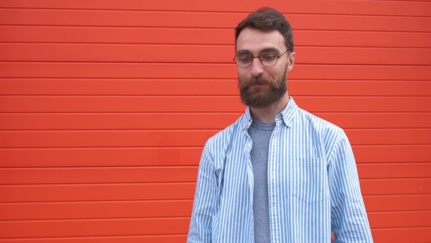 Portrait happy bearded guy with glasses takes the bags in his hands. shopping in the store