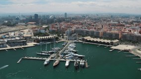 Aerial view over the Valencia marina port on a sunny summer day, 4k short video parallax