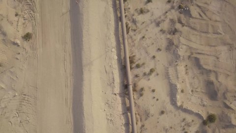 Long oil pipeline in the desert – birds eye view (4K)