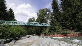 Slow motion clip of pedestrian bridge over Fitzsimmons Creek, in Whistler Village, Whistler BC, Canada.