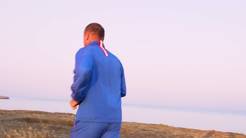 a man runs in the morning at dawn doing sports