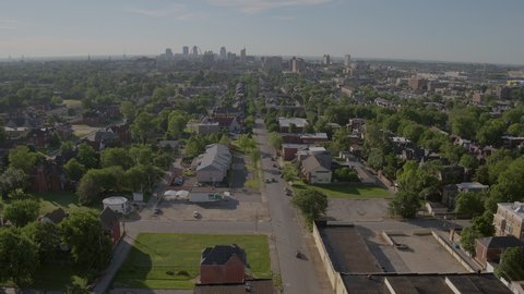 Aerial pull away from downtown St. Louis skyline and over lower class neighborhood