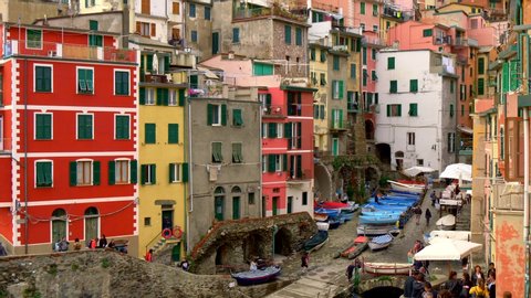 Colorful houses in Riomaggiore, Italy. Townscape background. Riomaggiore is one of the Cinque Terre towns and a popular tourist destination. Tilt shot, UHD
