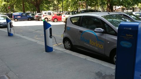 Turin, Italy, Piedmont, July 2019. Electric car rental, parking with fast charging points. Filmed with pan Lo. 25 Fps