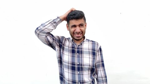 Portrait of confused handsome bearded man in blue checkered shirt standing scratching his head and looking away and thinking with puzzlement face. indoor studio shot isolated on white wall background.