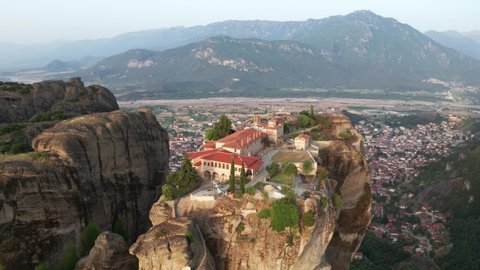 Greece, Meteora, Kalampaka city Aerial view of slide from drone on panorama of mountain range. View of cliffs of Meteora and monasteries of Meteora. Many ancient Orthodox monasteries. Travel. Tourism