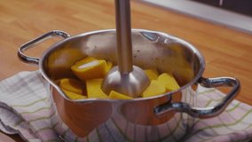 Preparing healthy mashed sweet potato with coconut milk. Clip represents healthy paleo eating, autoimmune disease prevention and is an example of a low carb high fat keto diet.