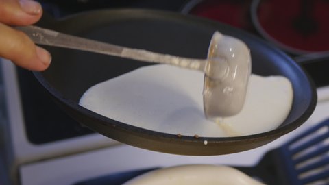 Baking Pancakes On A Frying Pan On Kitchen Stove.