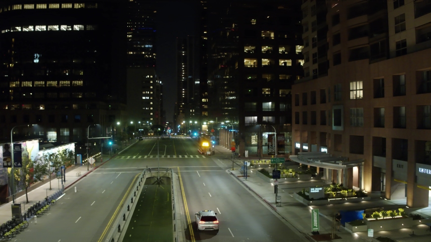 Establishing Aerial View Dow Town Looking at traffic at Night Following Cars