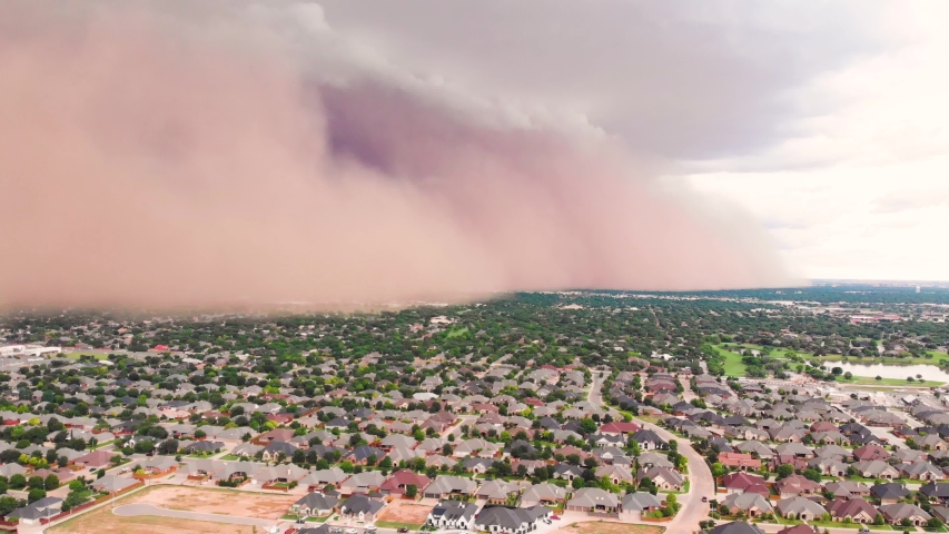 4K Ariel footage tilting as drone rises of a giant dust storm or haboob approaching a suburb in Lubbock, Texas
