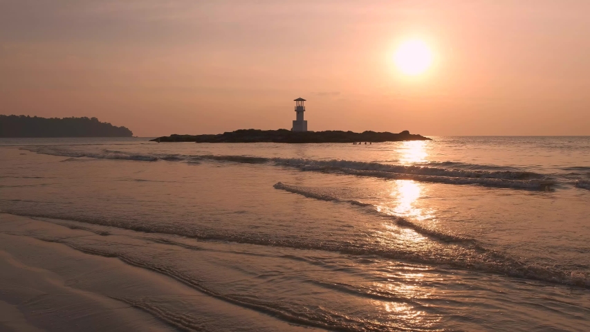 Lighthouse with the sunset at Nang Thong Beach Khao Lak Thailand. Soung of the sea. | Shutterstock HD Video #1032753590