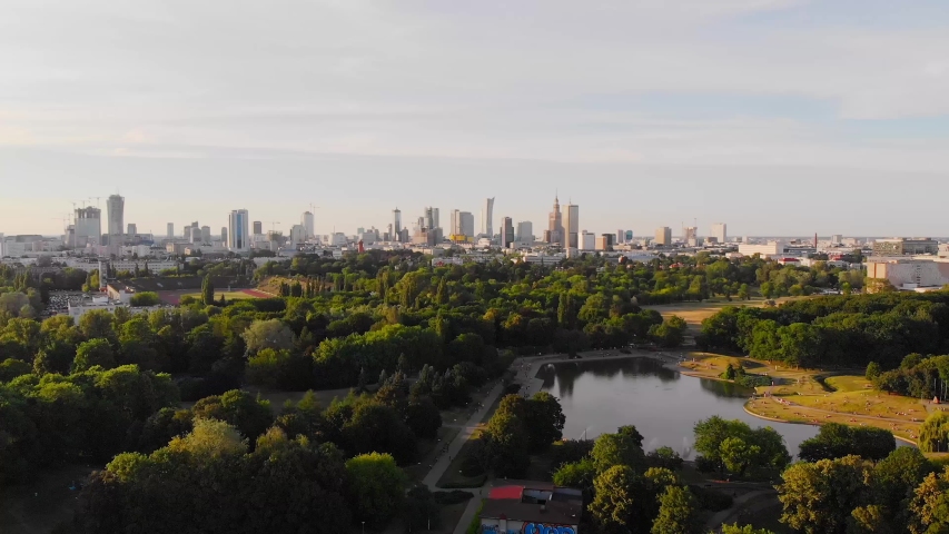Pole Mokotowskie Warsaw Park field with lake and city aerial view at the sunset. Royalty-Free Stock Footage #1032755720