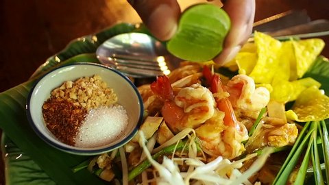 
Slow motion, Squeezing lemon into  'Pad Thai Goong Sod", Thai food