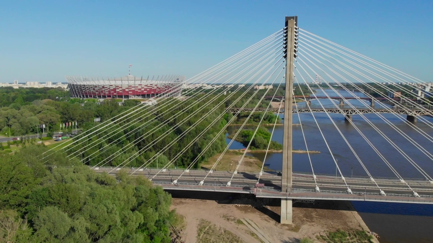 View of Swietokrzyski Bridge On Sunny Day and the national stadium. Aerial Shot. Warsaw, Poland.
