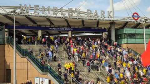 London, England / United Kingdom - May 30 2015: Time lapse of people walking downstairs from Wembley Park Station to Wembley Stadium