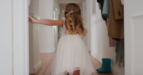 happy little girl running through house wearing excited to play outside child having fun on weekend morning enjoying wearing pretty white dress 4k