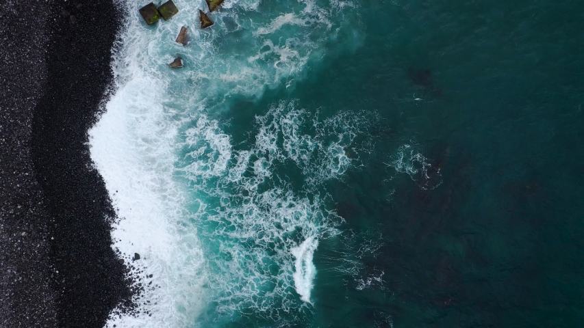 Top view of a deserted black volcanic beach on the Atlantic Ocean. Coast of the island of Tenerife. Aerial drone footage of sea waves reaching shore | Shutterstock HD Video #1032775004