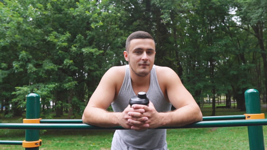 Portrait of smiling athletic man dressed in sportswear after workout in the sports ground