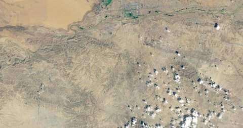 Very high-altitude overflight aerial of Tengger Desert Solar Park, China's northwestern Ningxia province. Clip loops and is reversible. Elements of this image furnished by NASA